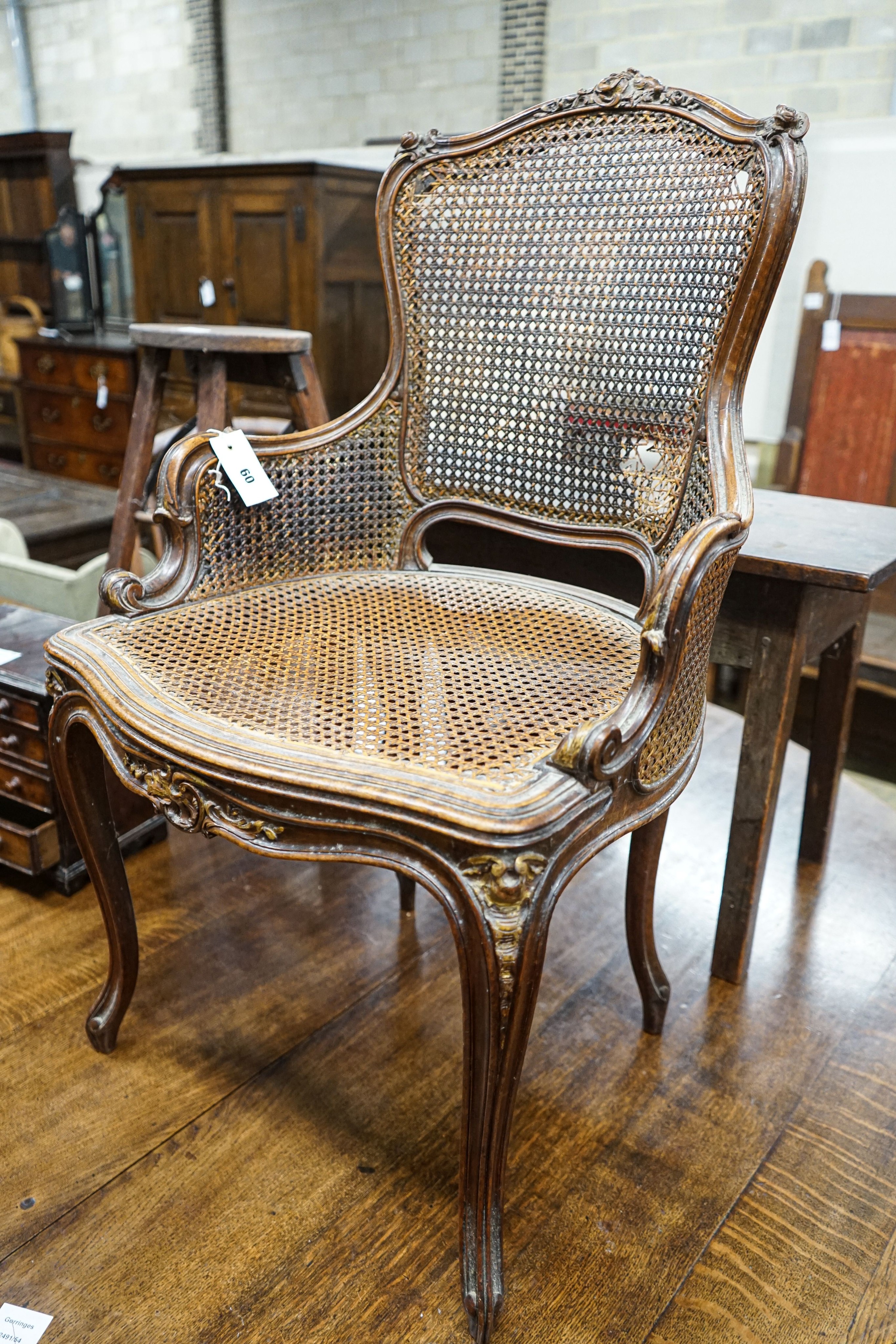 A 19th century French carved and caned walnut salon chair, width 52cm, depth 46cm, height 87cm